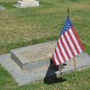 One of many flags hovering over veterans' graves at the Lemoore Cemetery.